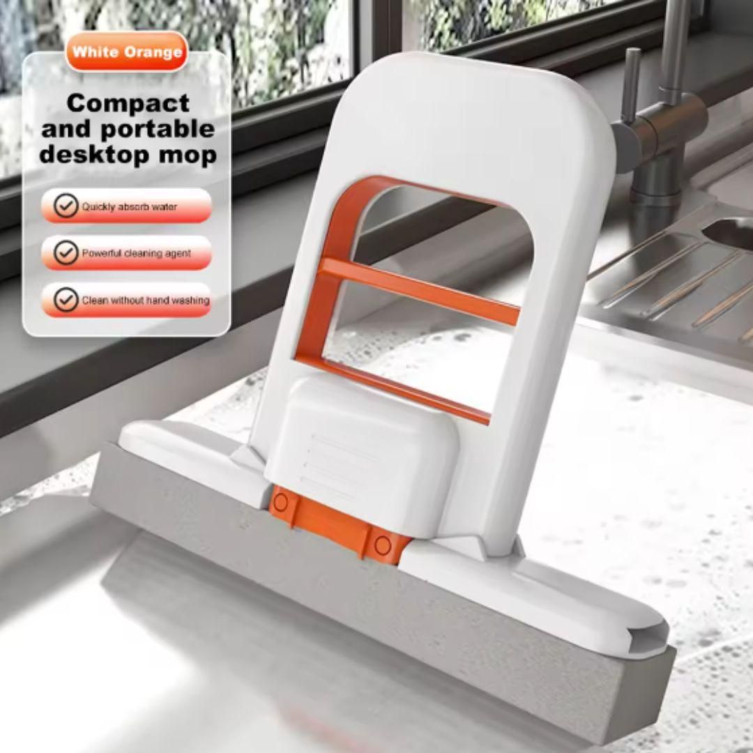 Compact and portable desktop mop with white and orange design, used on a glass surface.