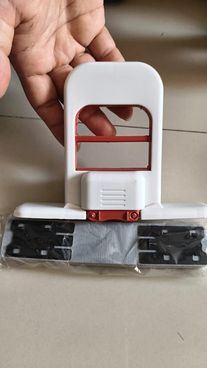 Hand holding a white and red tool with a clear plastic cover on a neutral background